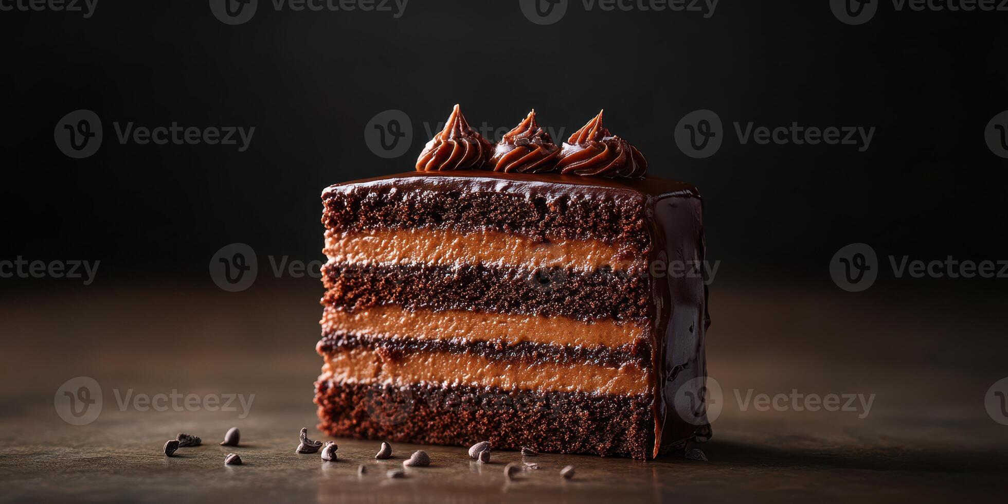 Rich chocolate layer cake with creamy frosting presented on a dark wood surface photo