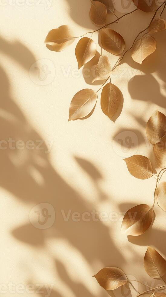 Delicate shadows of golden leaves create an elegant composition on a warm, neutral background in soft afternoon light photo