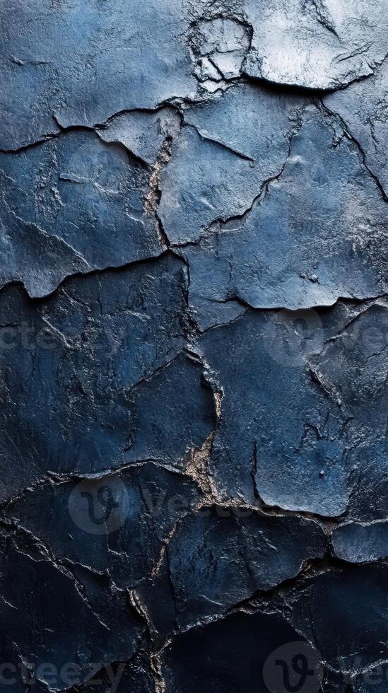 Dark textured surface with deep cracks and uneven patterns showing signs of wear and aging in a close-up view photo