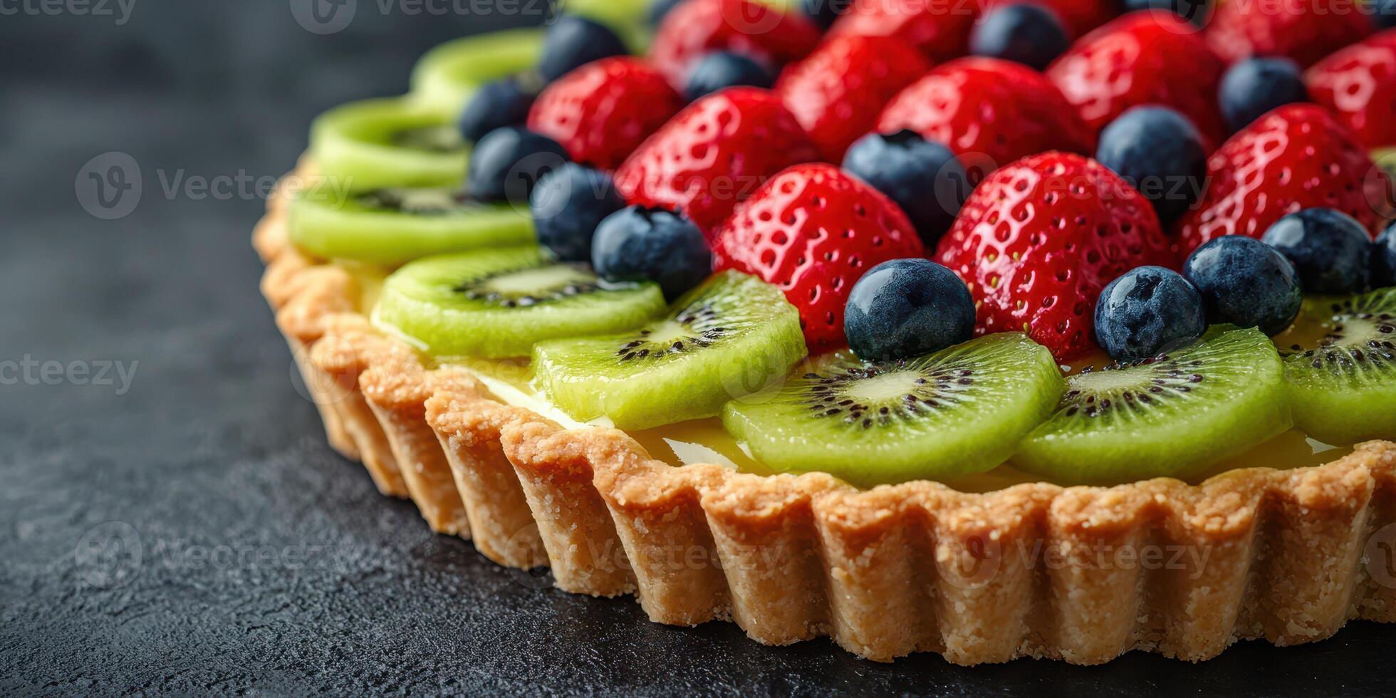 Fresh fruit tart made with strawberries, blueberries, kiwis, and green apples showcased on a dark backdrop for dessert lovers photo