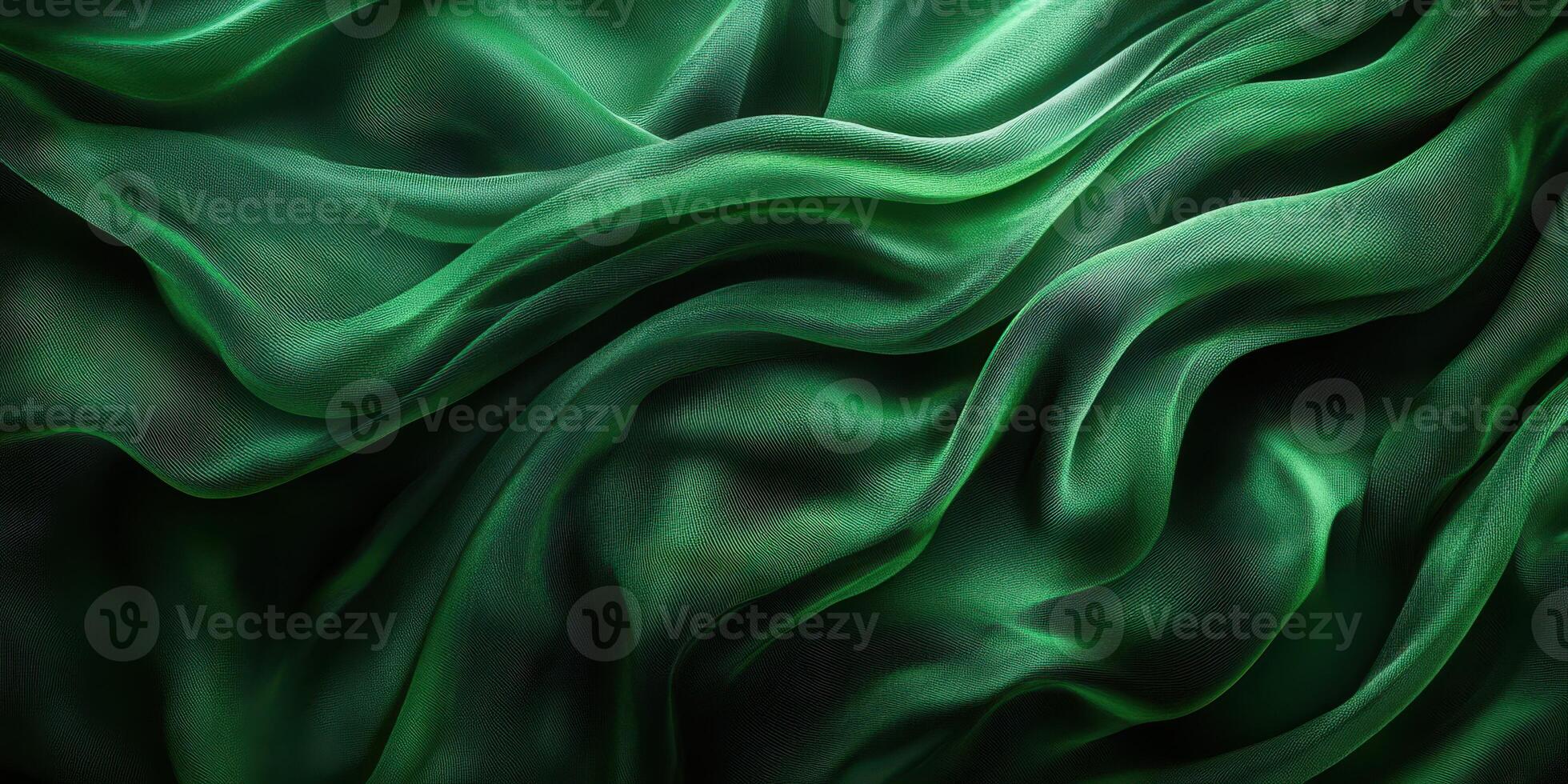 Elegant green silk fabric draping gracefully in soft waves, creating a luxurious visual texture photo