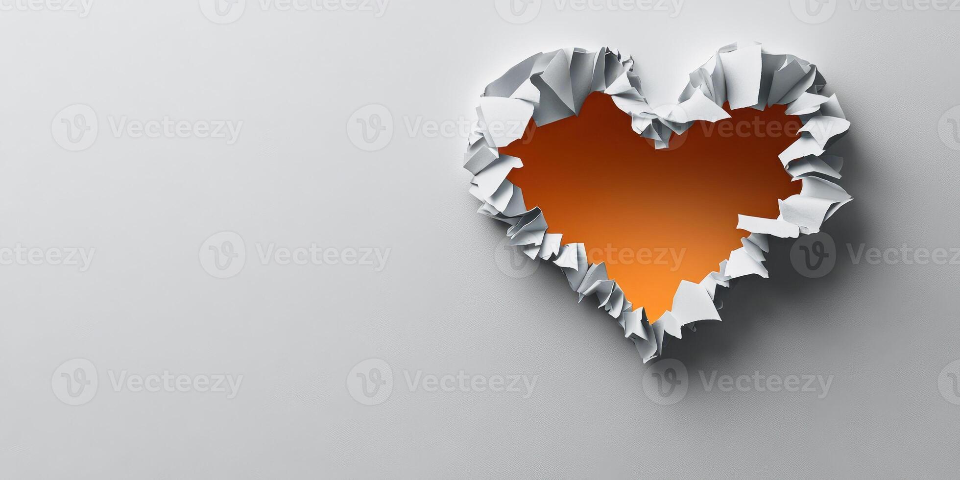 Creative heart shape made from torn paper revealing orange color against a light background expressed in an artistic way photo