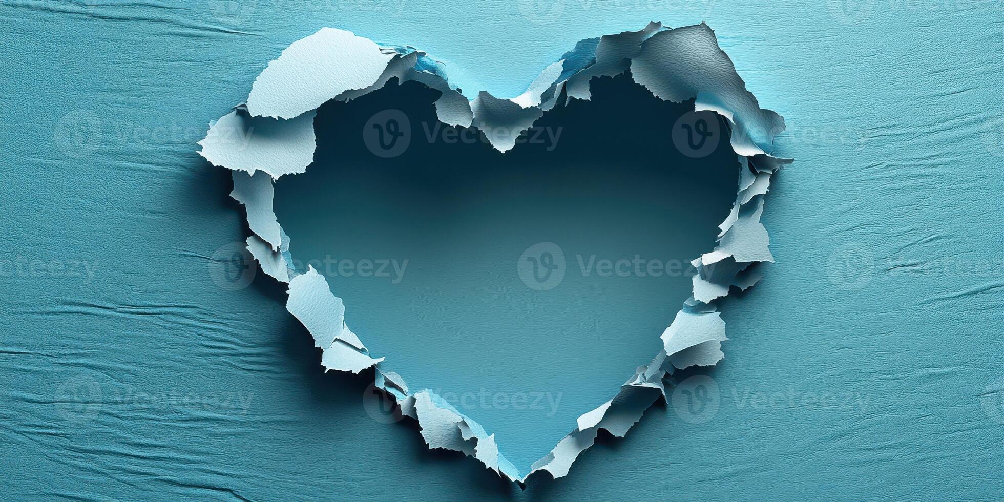 Torn paper heart shape reveals textured blue background with soft lighting photo