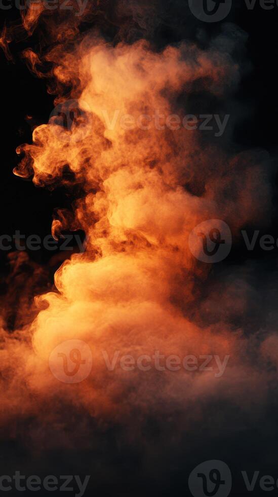 Wisps of orange and gray smoke rise dramatically in a dark space, creating a captivating visual effect photo