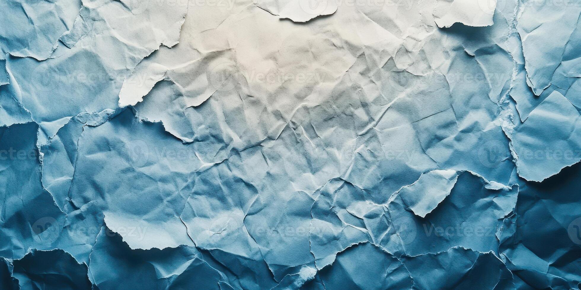 Crumpled blue paper texture with light and shadows creating an abstract background effect photo
