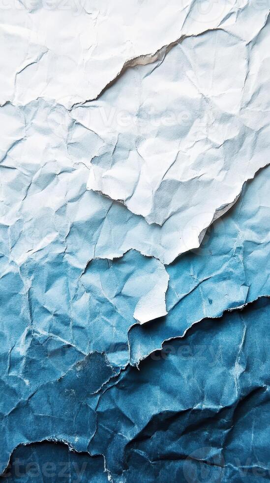 Textured layers of crumpled paper showcasing a gradient from light to dark blue, creating an artistic backdrop for design photo