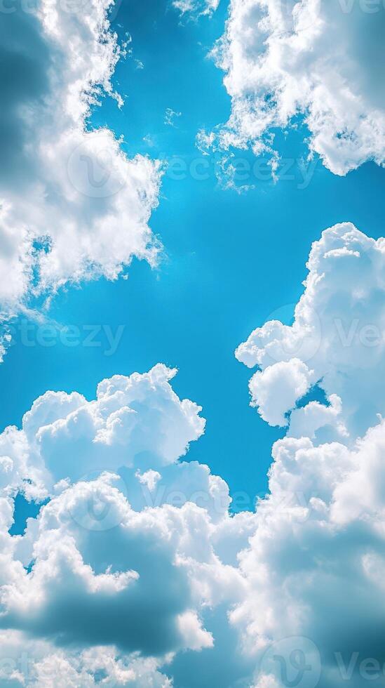 Beautiful fluffy clouds in a bright blue sky during midday creating a serene atmosphere photo