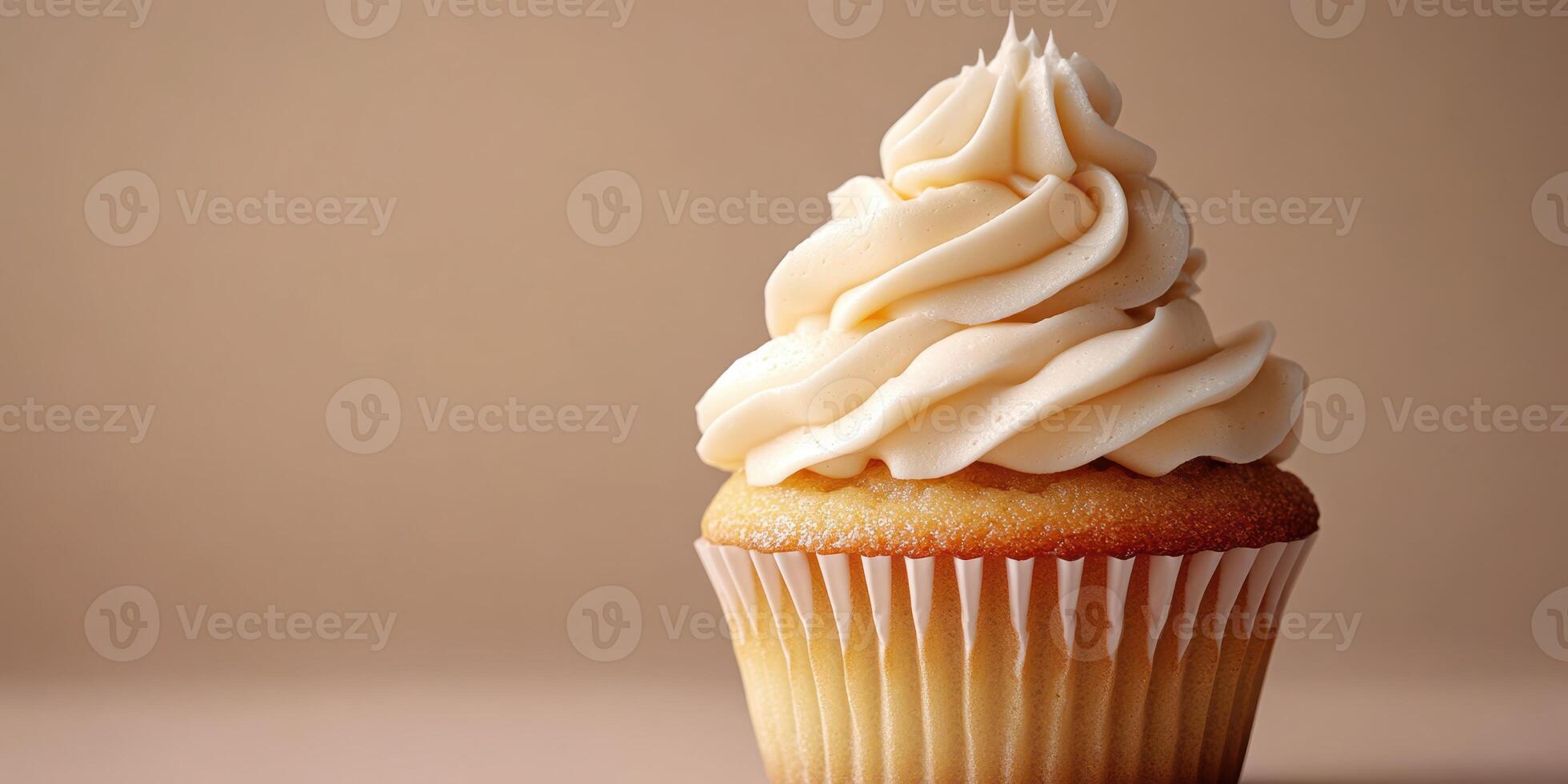Delicious vanilla cupcake with creamy frosting displayed on a neutral background photo