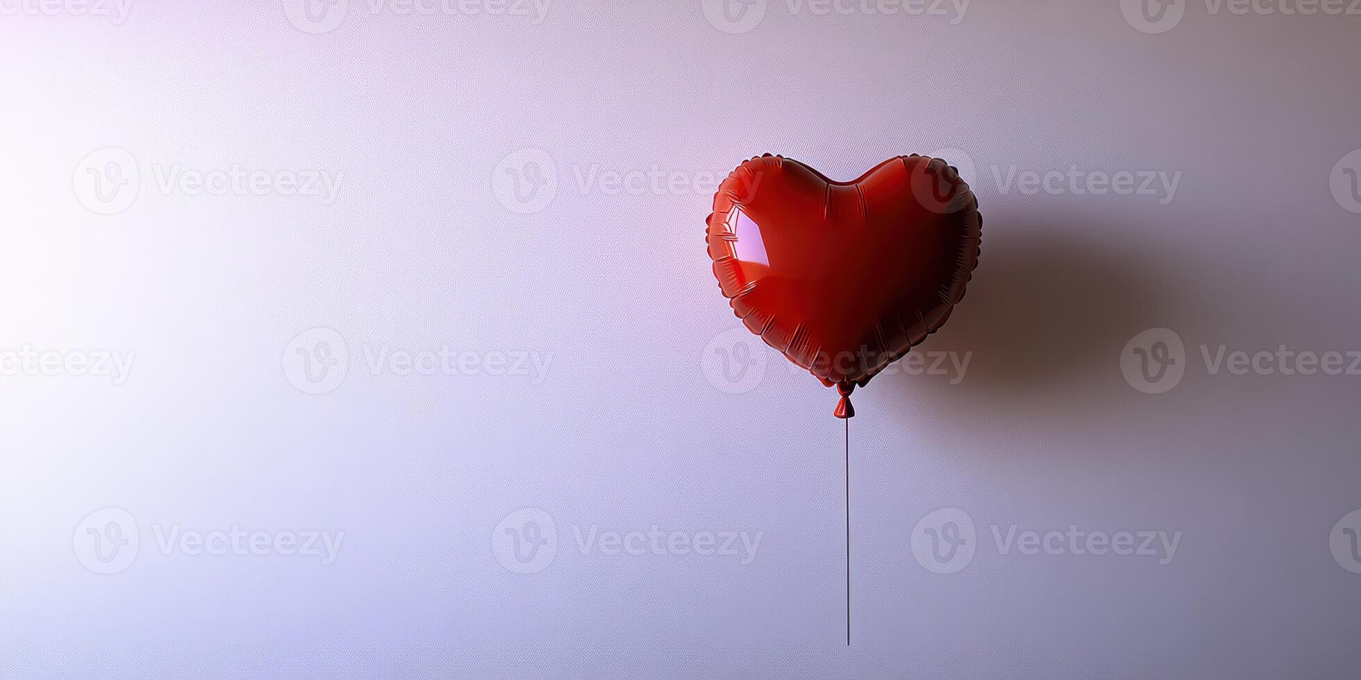 Heart-shaped red balloon floating against a plain background is a symbol of love and celebration photo