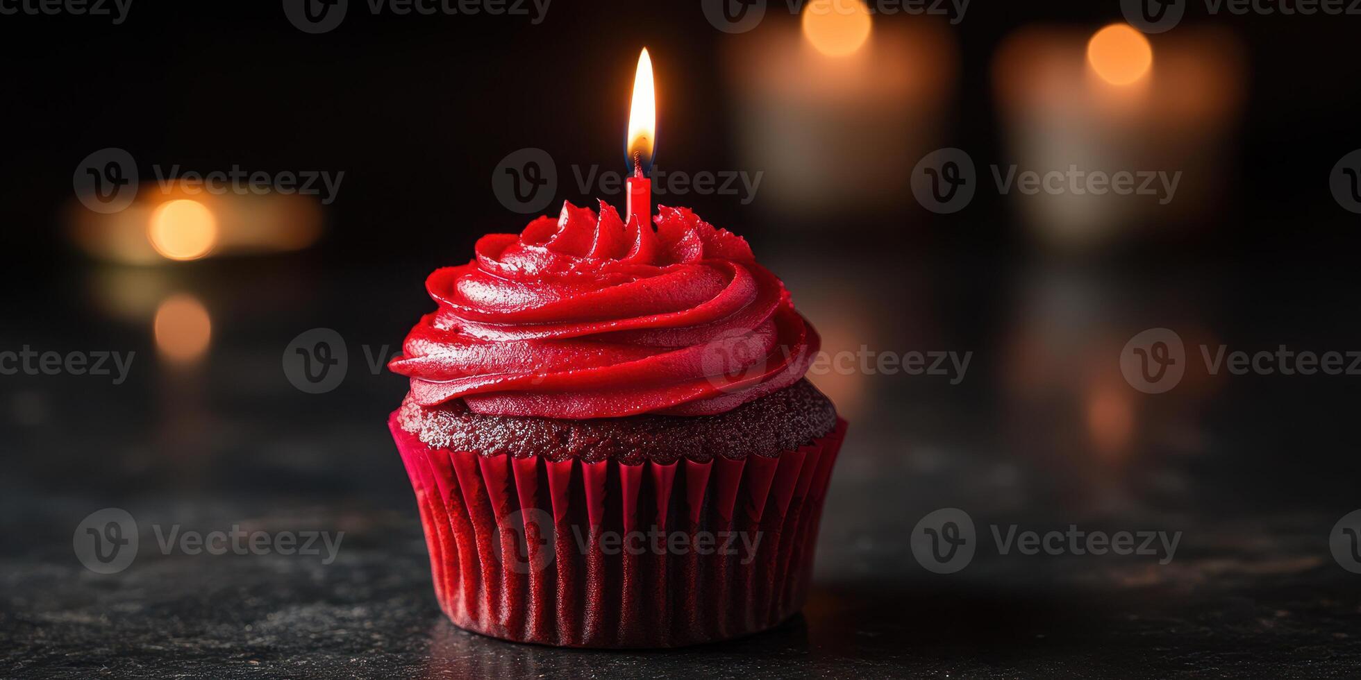 Delightful red velvet cupcake with candle glowing in warm light setting perfect for special celebrations photo