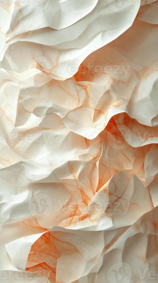 Crumpled fabric texture with soft shadows and subtle orange hues creating a warm and inviting atmosphere in a minimalist setting photo