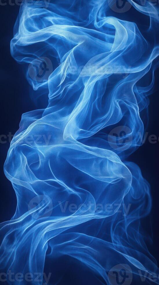Ethereal blue fabric swirls gracefully against a dark background creating a tranquil ambiance photo
