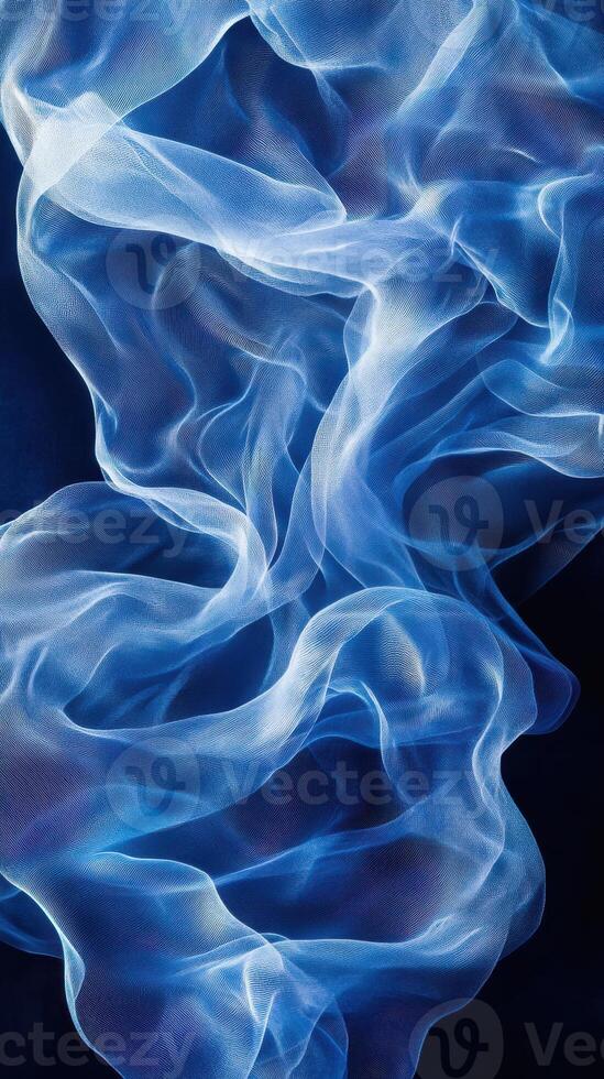 Soft blue fabric waves create a mesmerizing abstract pattern against a dark background in this serene artistic display photo