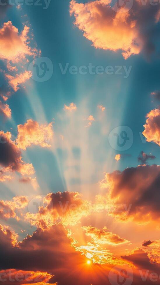 Dramatic sunset with vibrant clouds and rays of light shining through in a clear sky at dusk photo