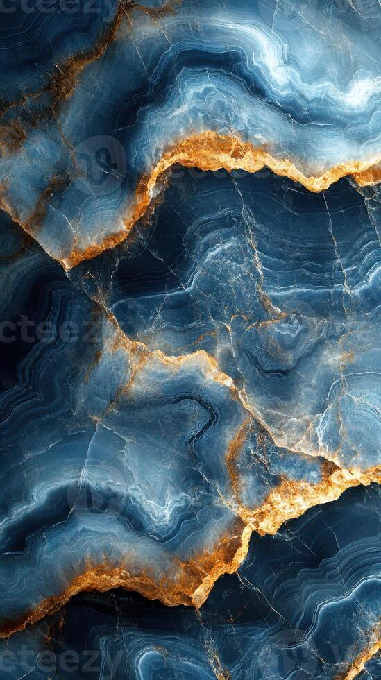 Abstract blue and gold stone pattern with swirling textures and intricate details forms a captivating natural design photo