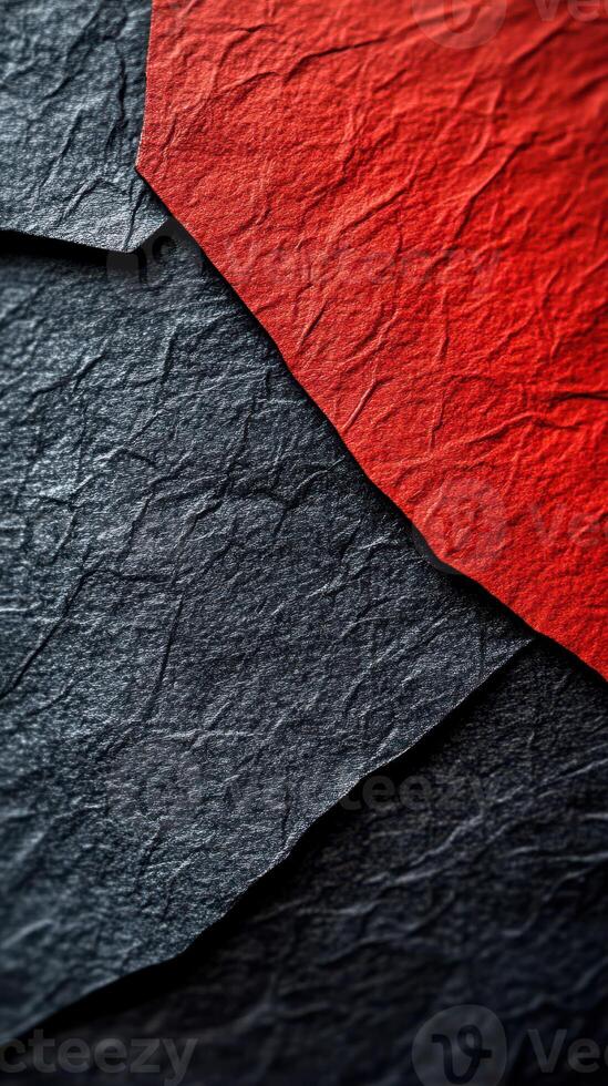 Textured black and red paper overlapping to create a striking visual contrast in a close-up view photo