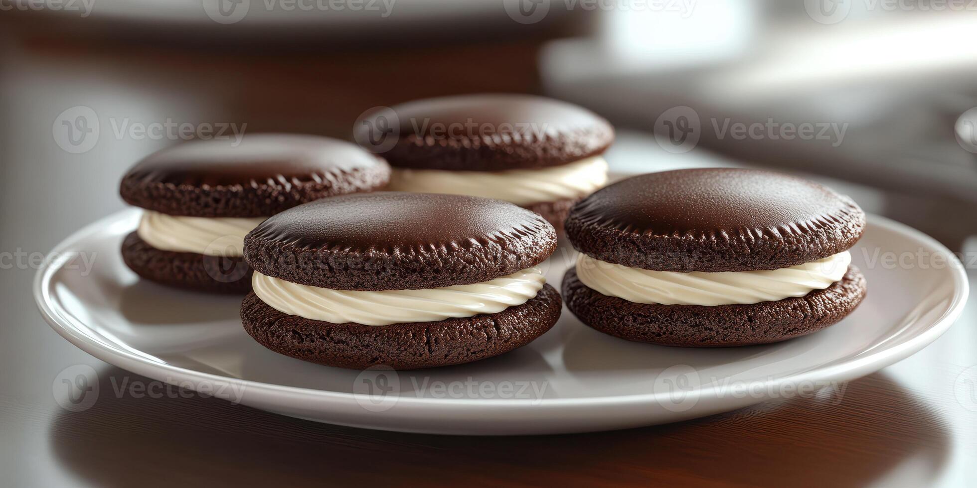 Decadent chocolate cream cookies arranged neatly on a white plate ready to be enjoyed for dessert photo