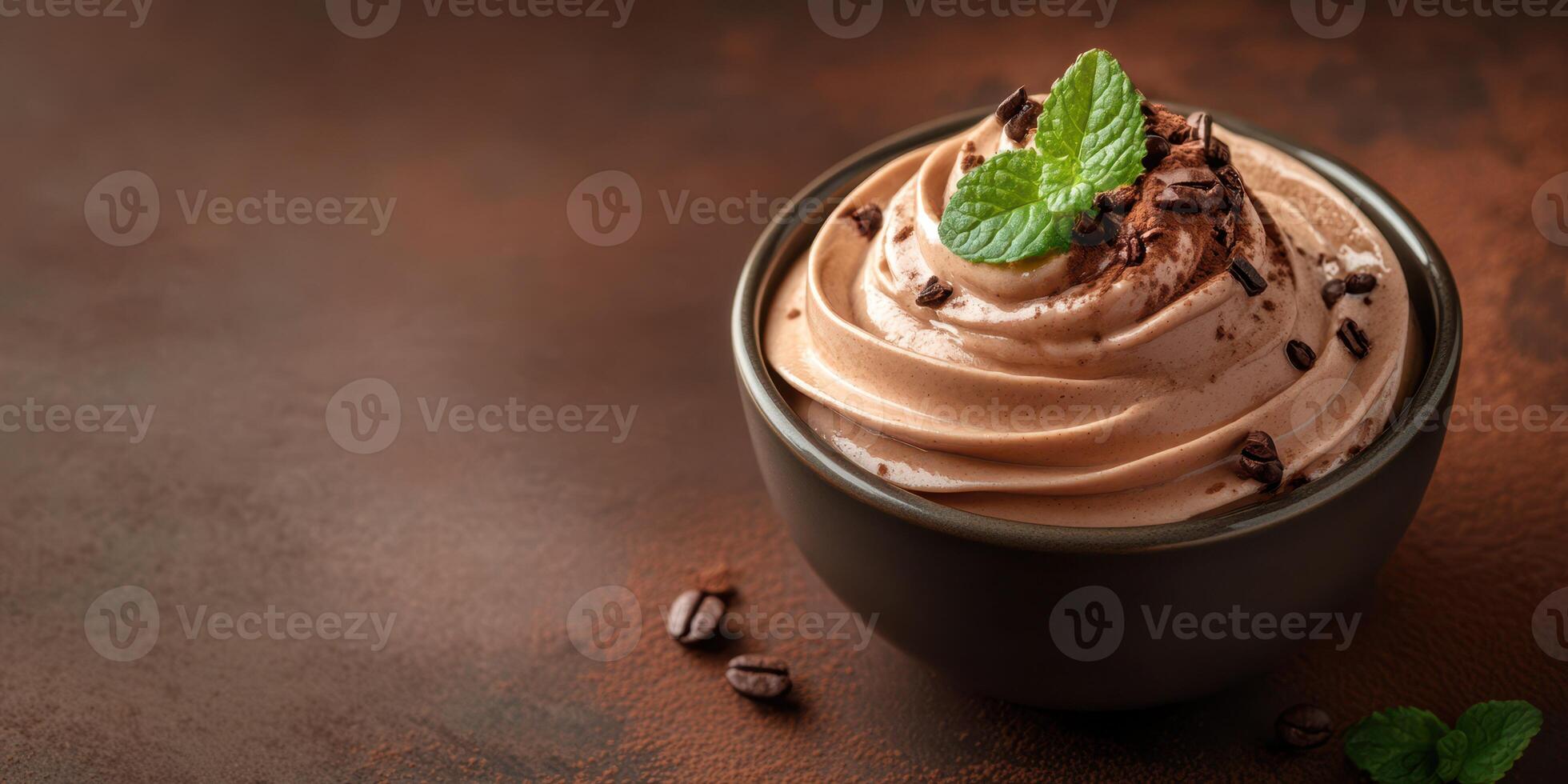 Delicious chocolate mousse topped with mint and chocolate shavings in a bowl on a rustic surface photo