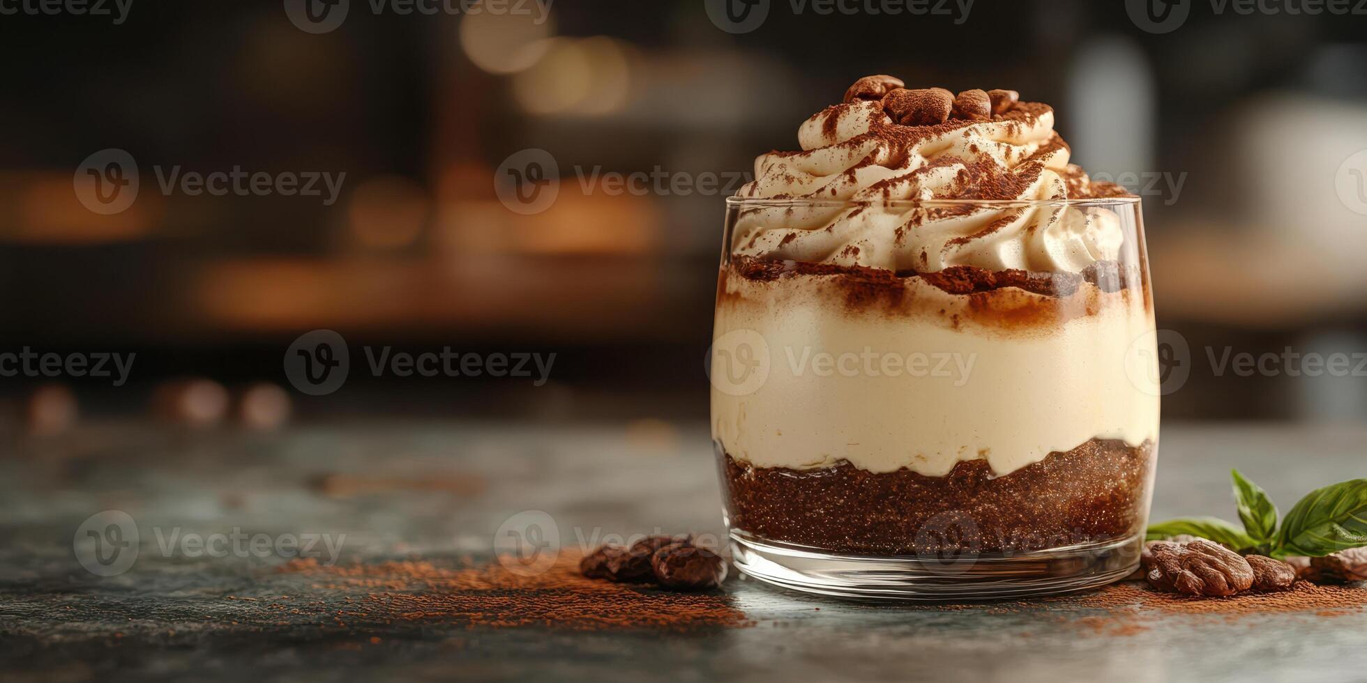 Dessert features layers of creamy mascarpone, coffee, and chocolate in an elegant glass on a wooden counter photo