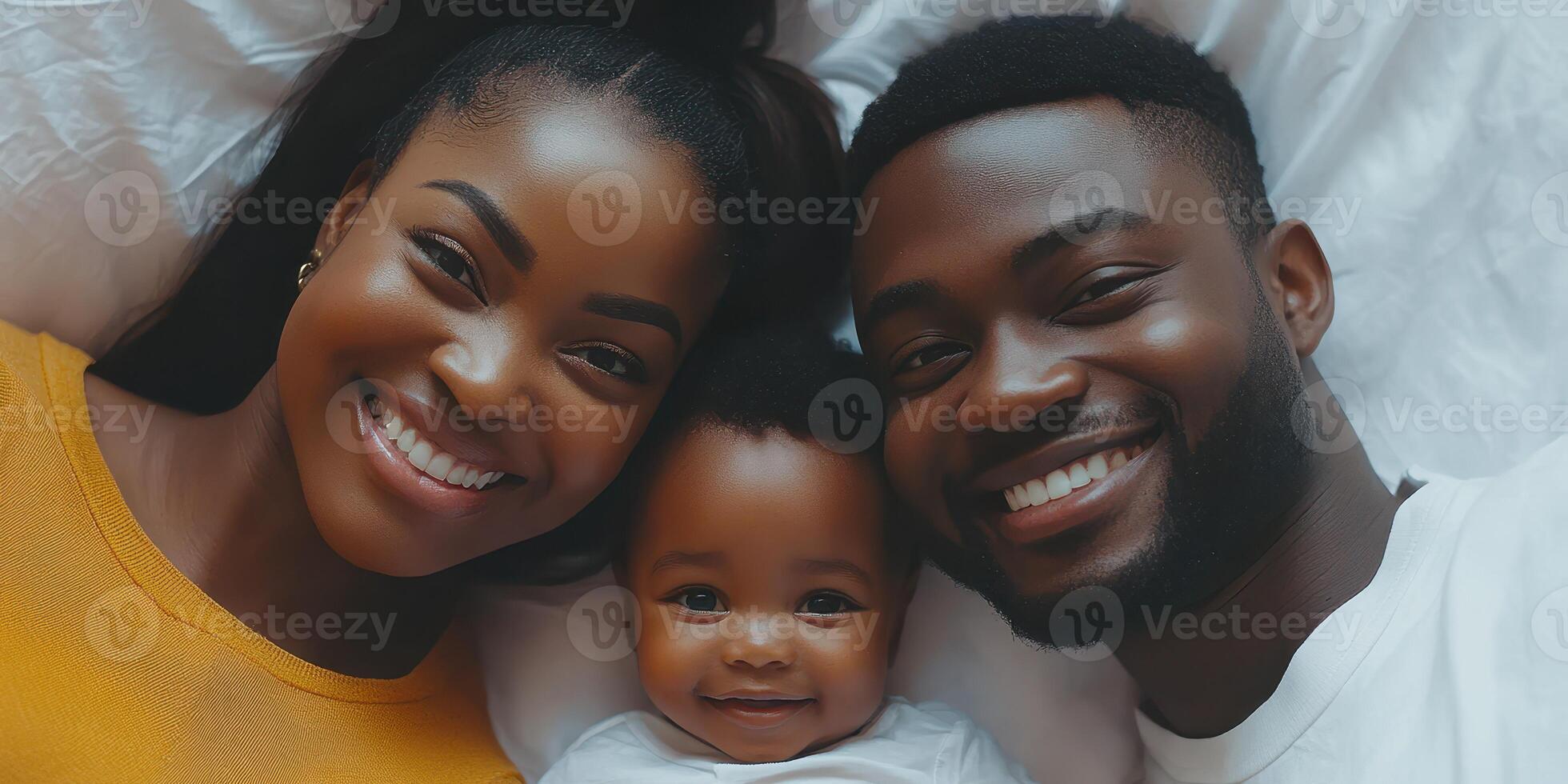 Family enjoying a joyful moment together while lying on a bed in a cozy setting at home photo