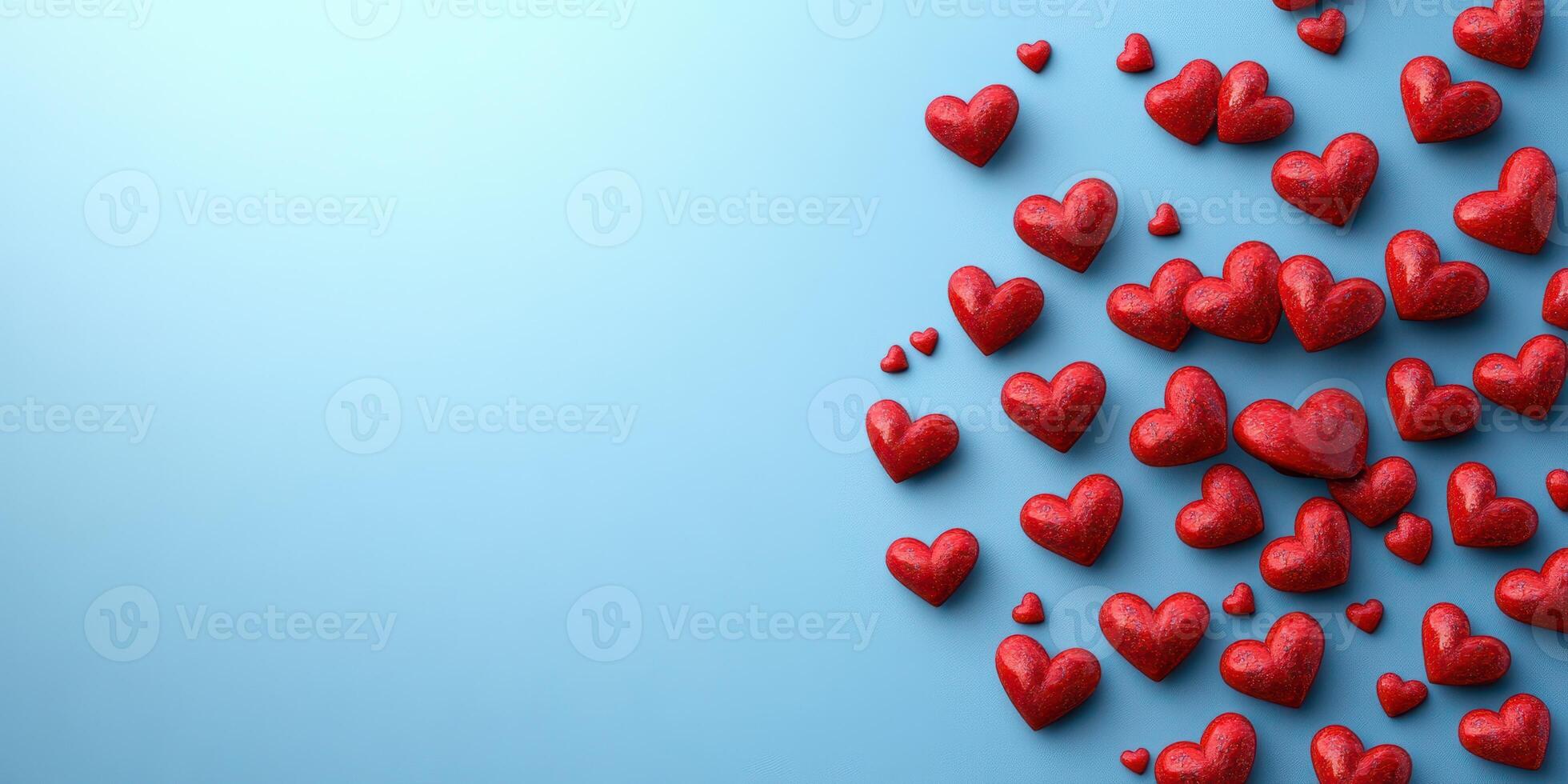Red hearts scattered artistically on a light blue background for romantic occasions and celebrations photo