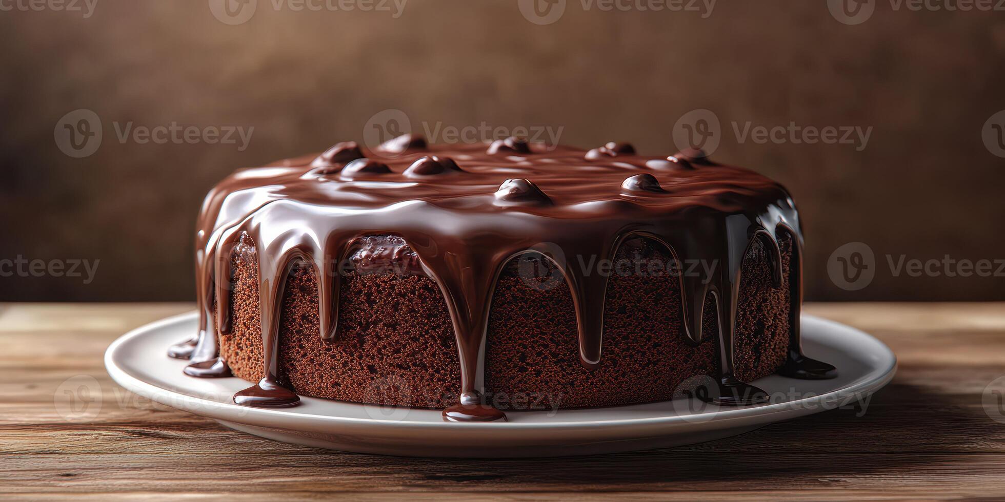 Decadent chocolate cake with glossy ganache served on a rustic wooden table photo