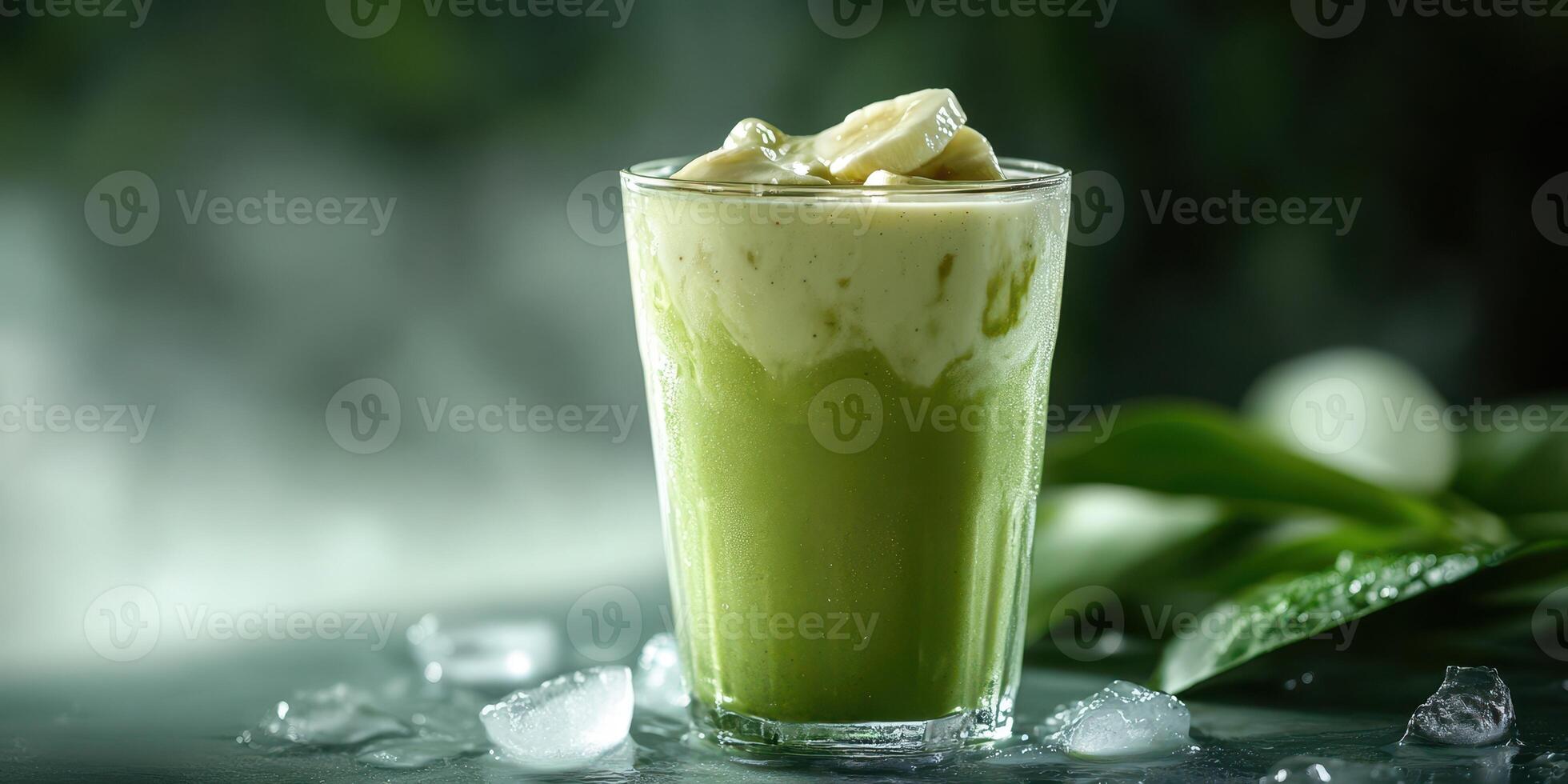 Creamy matcha drink served in a glass with ice and green tea leaves near the glass in a serene environment photo