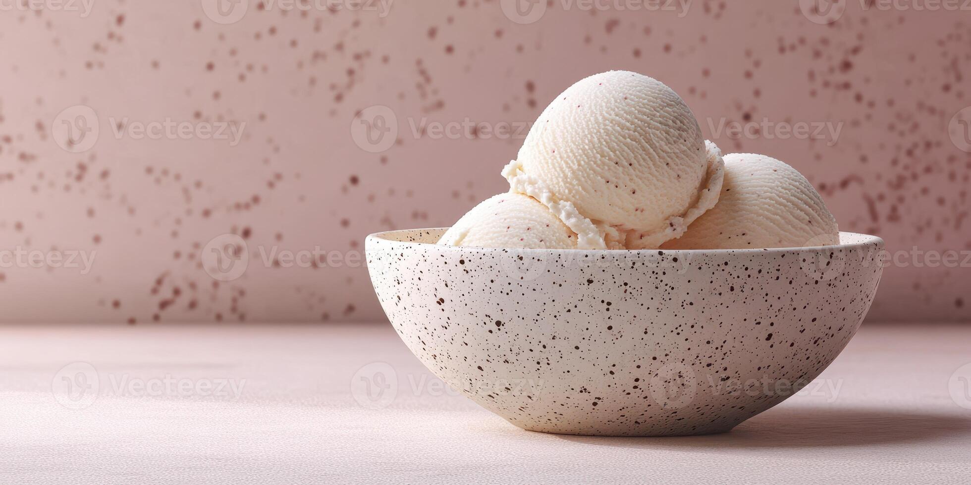 Delicious creamy vanilla ice cream balls served in a decorative speckled bowl on a pastel background photo