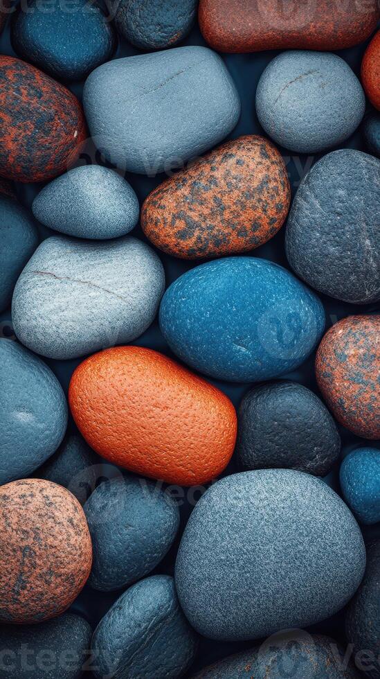 Colorful collection of smooth stones showcasing natural textures and shades in varied shapes photo