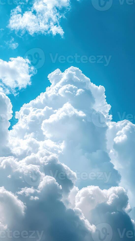 Fluffy white clouds drifting in a bright blue sky during a sunny afternoon photo