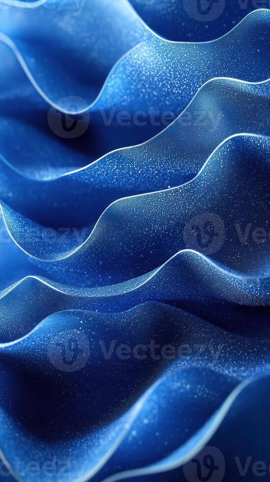 Flowing blue fabric displays delicate waves and shimmering texture in soft light photo
