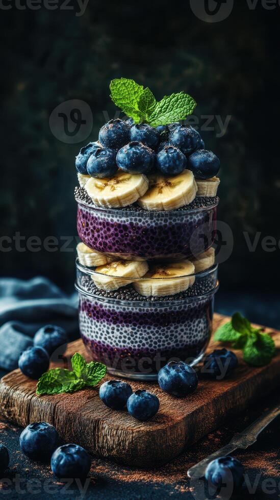 Delicious layered chia pudding with bananas and blueberries on a wooden surface photo