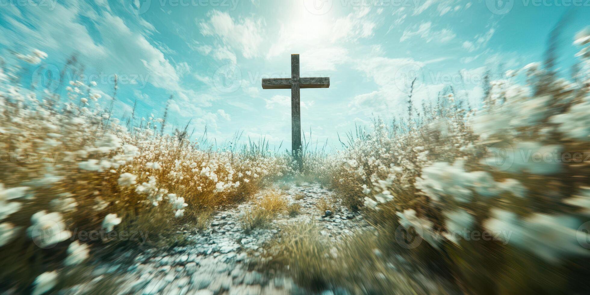 Cross stands tall in a field of blooming flowers under a bright sky during a tranquil afternoon photo
