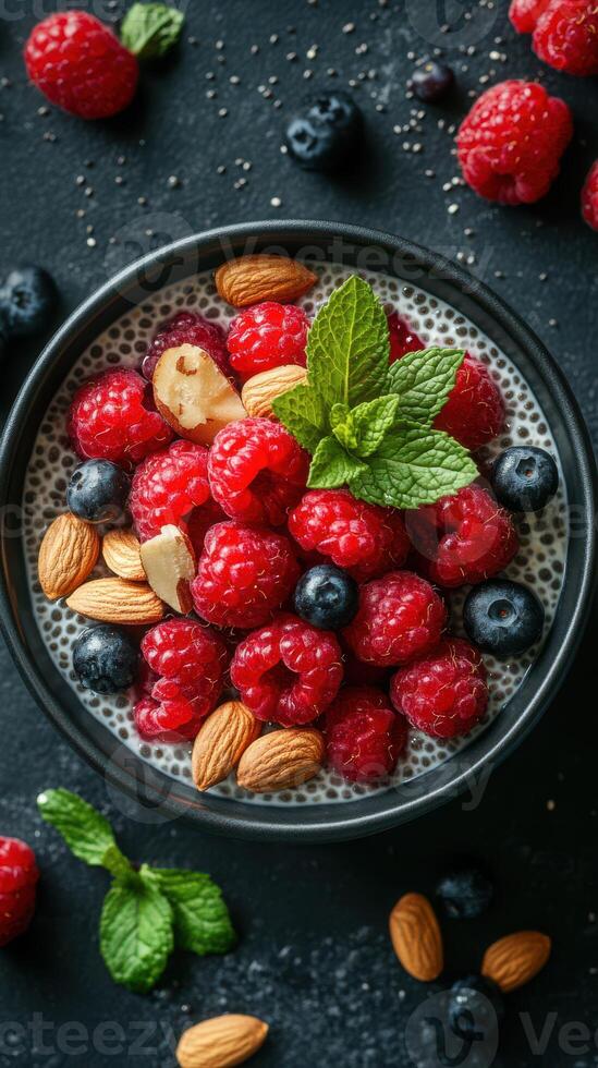Colorful bowl of chia seed pudding topped with fresh berries and nuts in bright kitchen setting photo