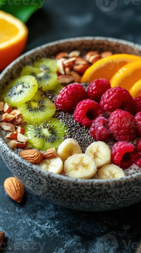 Healthy smoothie bowl with fresh fruits, nuts, and seeds on a textured surface in a cozy setting photo