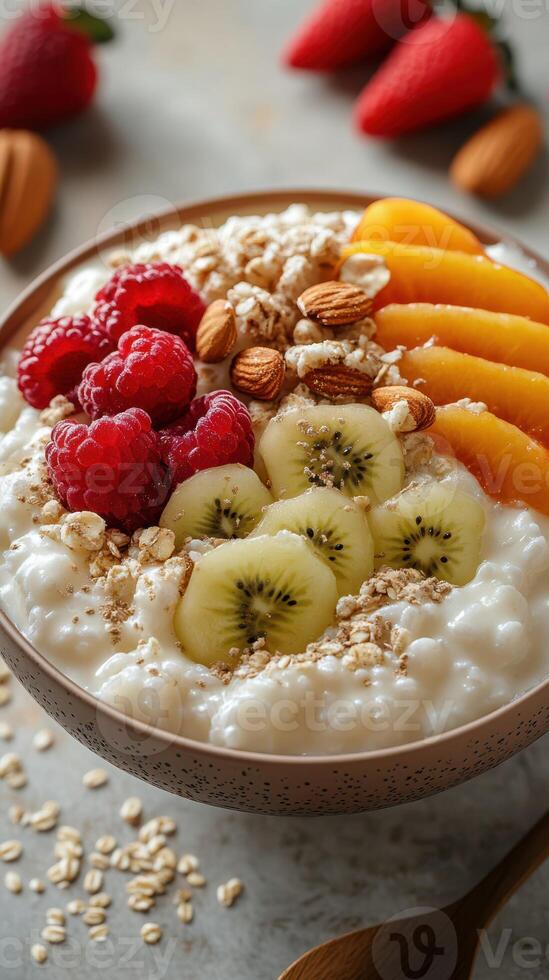 Healthy breakfast bowl with fruits, nuts, and oats prepared on a wooden table in a bright kitchen photo