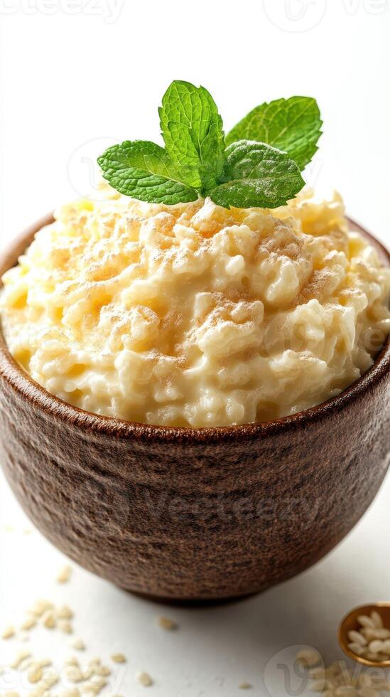 Creamy cottage cheese topped with fresh mint leaves in a rustic bowl on a bright background photo