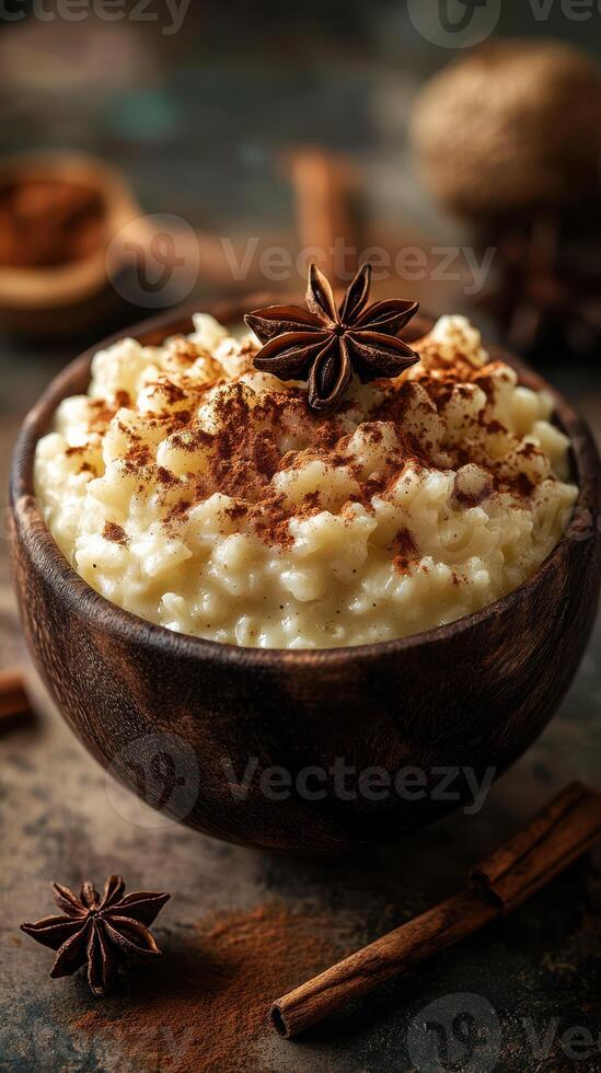 Creamy rice pudding served in a rustic bowl with spices on a wooden table during a cozy evening photo