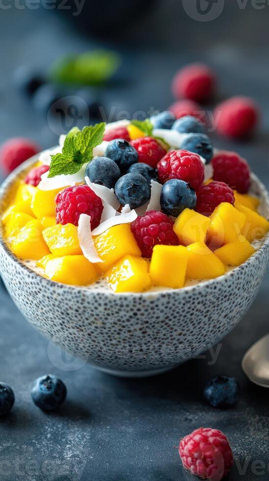 Delicious fruit and chia seed bowl topped with colorful berries and fresh mango photo