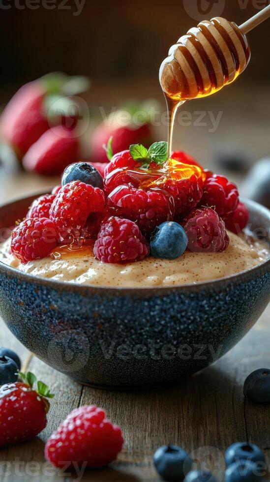 Delicious dessert featuring creamy yogurt topped with fresh berries and honey on a rustic wooden table photo