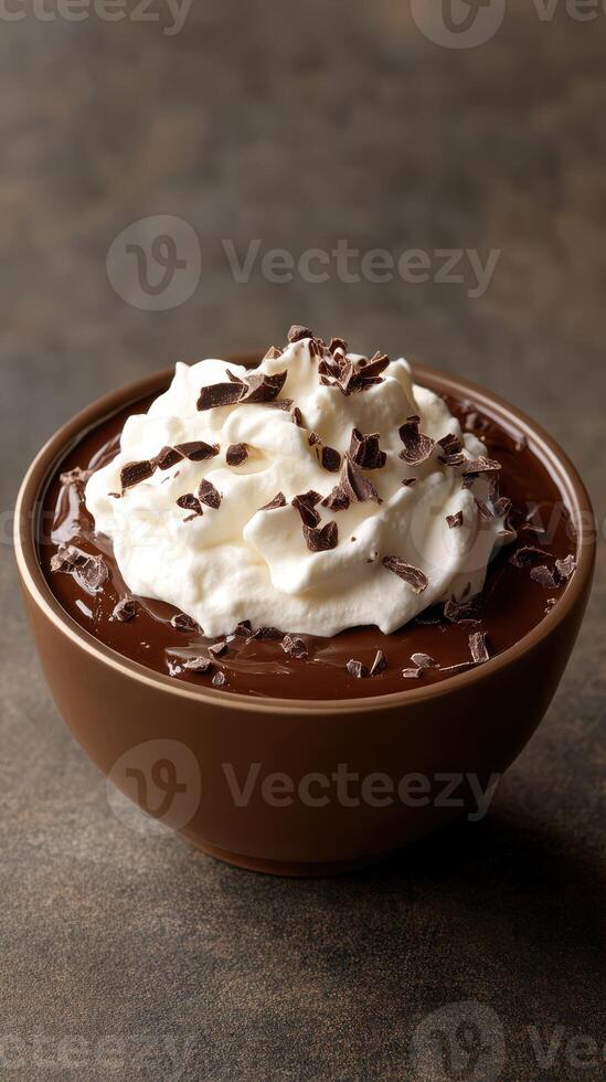 Creamy chocolate dessert topped with whipped cream and chocolate shavings served in a brown bowl photo