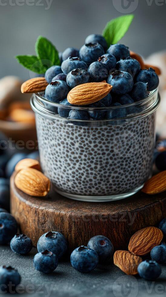Healthy dessert featuring chia seed pudding topped with fresh blueberries and almonds in a rustic setting photo