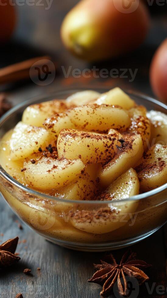 Sliced apples sprinkled with cinnamon and served in a glass bowl at a cozy kitchen setting during autumn photo