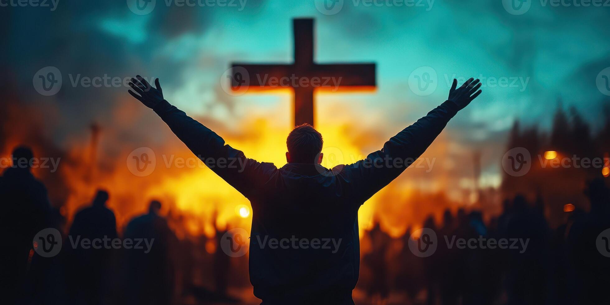 Worshippers gather at dusk to celebrate faith and unity during an outdoor service with a large cross in the background photo