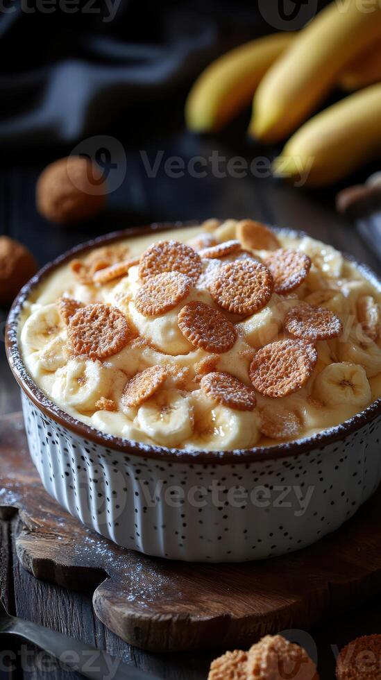 Creamy banana pudding topped with cookies in a rustic kitchen setting with fresh bananas nearby photo