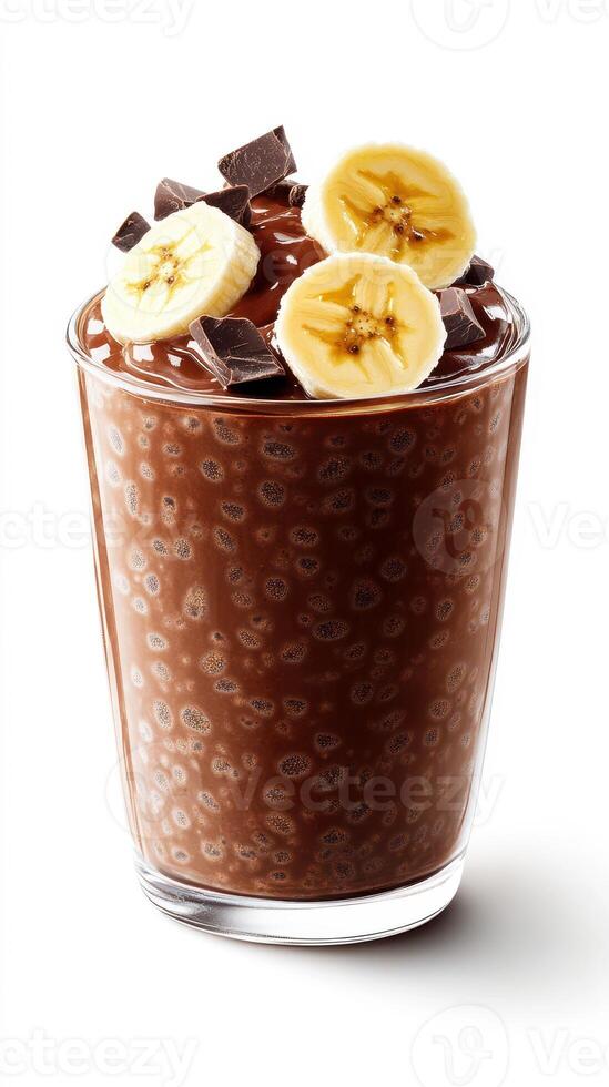 Chocolate chia pudding topped with fresh banana slices and chocolate pieces served in a clear glass cup photo