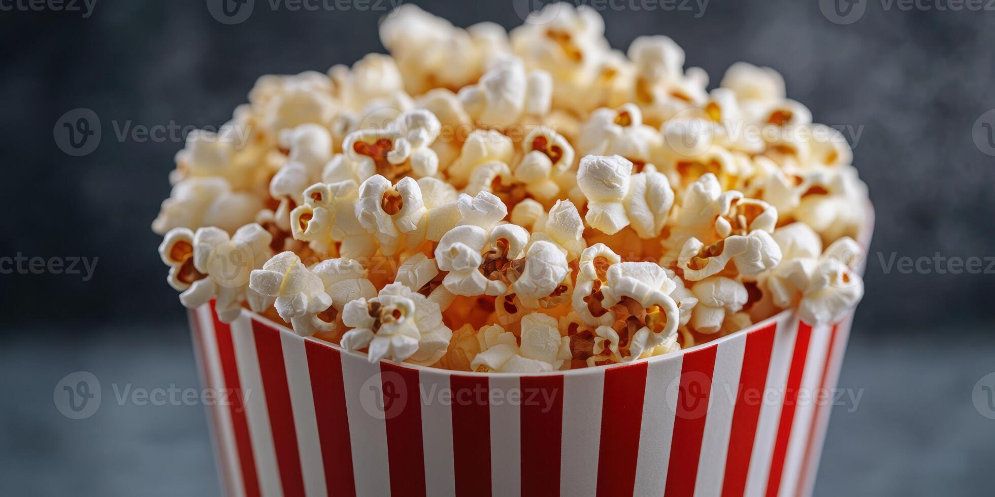 Freshly popped popcorn in a striped container ready for movie night at home or a special event photo