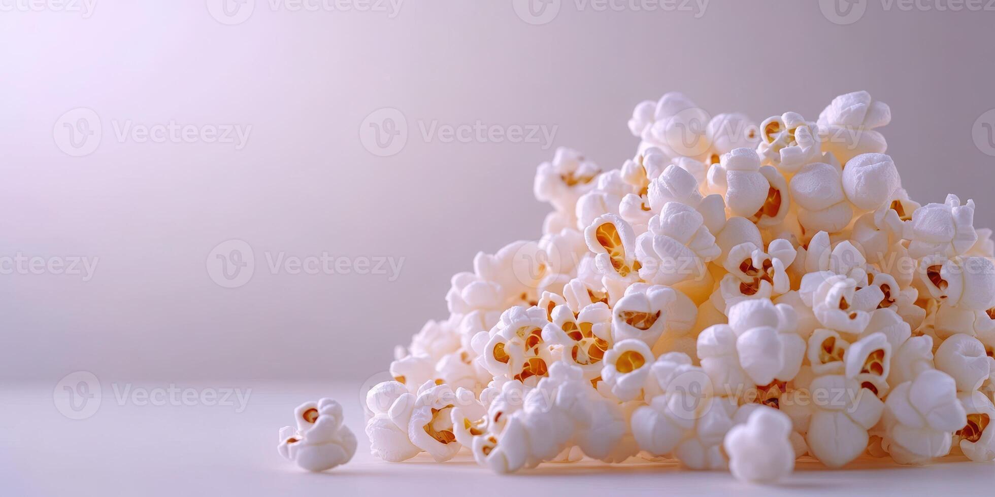 Freshly popped popcorn scattered on a clean, neutral surface creates a light and airy atmosphere photo