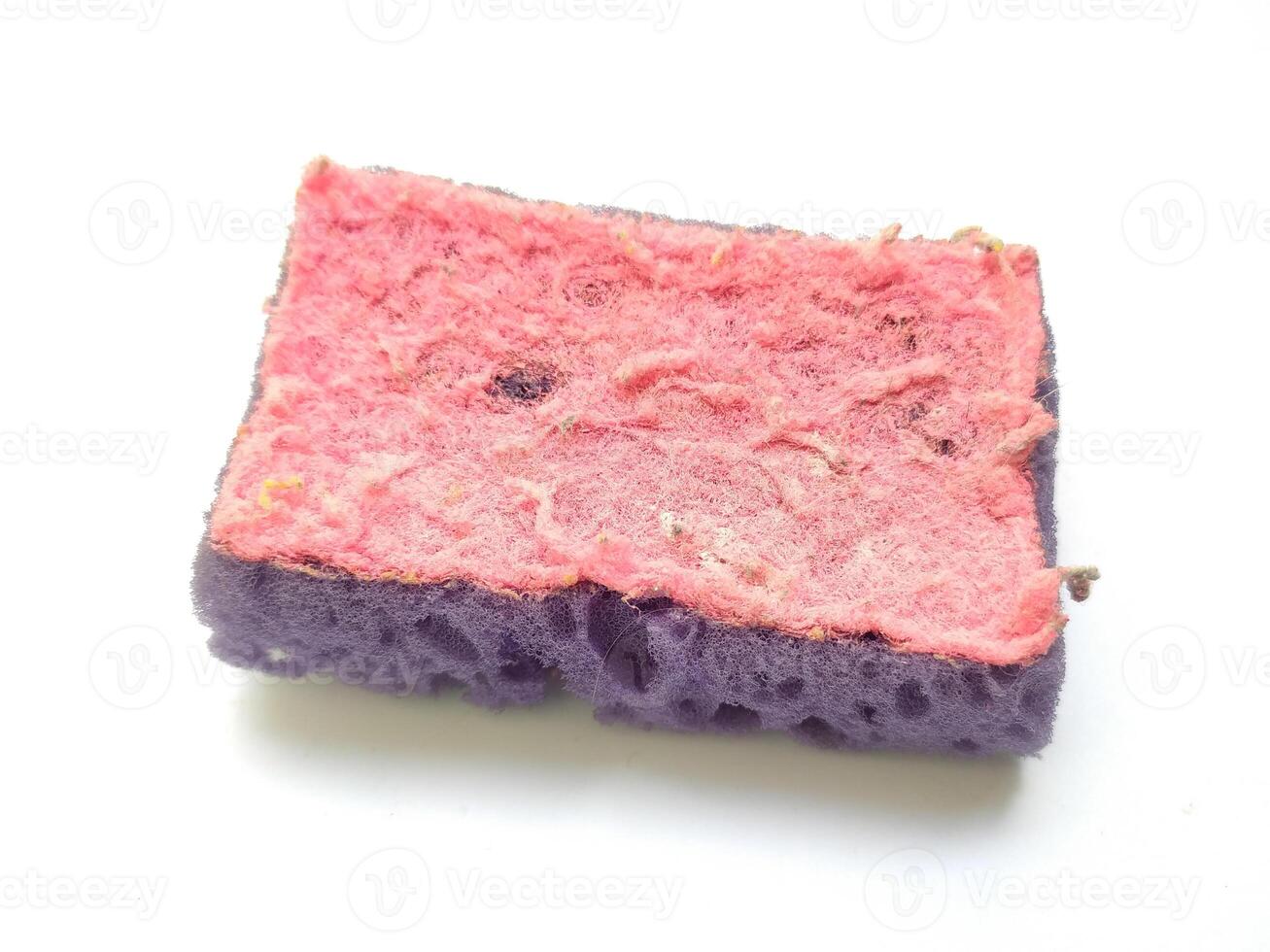 Closeup of a wellused, textured cleaning sponge. Its worn pink and purple layers show signs of hard work, symbolizing resilience and the passage of time. photo