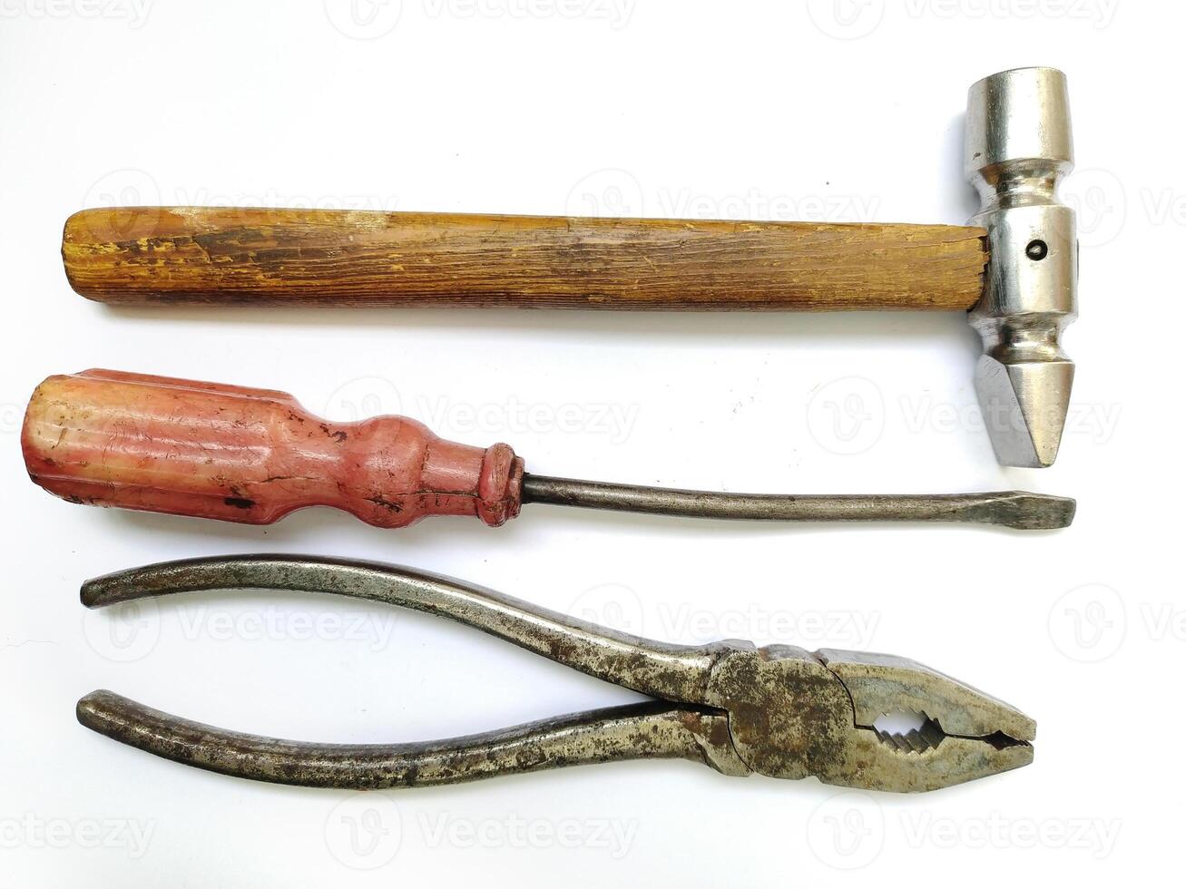 Vintage tools hammer, screwdriver, pliers. A classic still life showcasing aged craftsmanship. Perfect for DIY, repair, construction, or retro themes. Evokes feelings of nostalgia and hard work. photo